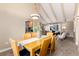 Open-concept dining space with vaulted ceiling, seamlessly connects to the kitchen and living room, enhancing flow at 7676 S Olive Cir, Centennial, CO 80112