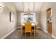Dining room with vaulted ceilings with natural light, complemented by a wooden table and matching chairs at 7676 S Olive Cir, Centennial, CO 80112