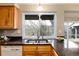This kitchen features granite countertops and a large window that offers a beautiful view of the outside at 7676 S Olive Cir, Centennial, CO 80112