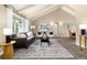 Bright living room featuring vaulted ceilings, a large window, and stylish furniture arrangement on neutral carpet at 7676 S Olive Cir, Centennial, CO 80112