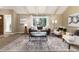 Cozy living room with vaulted ceilings, a large window, and a stylish area rug that complements the decor at 7676 S Olive Cir, Centennial, CO 80112