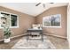 Well-lit home office featuring a stylish desk, comfortable chair, and large windows offering serene views at 7676 S Olive Cir, Centennial, CO 80112