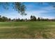 Open park view with soccer nets, large open field, and mature trees, ideal for recreation at 7676 S Olive Cir, Centennial, CO 80112