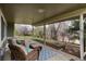 Covered outdoor patio with comfortable seating and view of landscaped backyard at 7676 S Olive Cir, Centennial, CO 80112