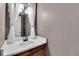 Charming half bathroom with a classic vanity, white sink, and decorative mirror, perfect for guests at 4782 E Costilla Ave, Centennial, CO 80122
