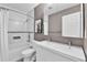 Modern bathroom boasts double vanity, white cabinets, modern fixtures, and tub with shower at 4782 E Costilla Ave, Centennial, CO 80122