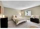 Neutral bedroom with a queen-sized bed, window, and a trunk for storage at 4782 E Costilla Ave, Centennial, CO 80122