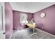 Cozy bedroom featuring purple walls, gray carpet, and a modern desk setup, ideal for a home office or study at 4782 E Costilla Ave, Centennial, CO 80122