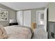 Well-lit bedroom with neutral color scheme, closet space, and access to the hallway at 4782 E Costilla Ave, Centennial, CO 80122
