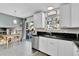 Bright kitchen features white cabinets, black backsplash, stainless steel appliances, and opens to a dining area at 4782 E Costilla Ave, Centennial, CO 80122