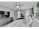 Bright main bedroom with neutral color palette, television, and direct access to ensuite bathroom and closet at 4782 E Costilla Ave, Centennial, CO 80122