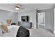 Neutral main bedroom features a ceiling fan, television, contemporary decor, and access to ensuite bathroom at 4782 E Costilla Ave, Centennial, CO 80122