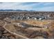 Scenic aerial view of modern townhomes surrounding a central park with a pond and walking paths at 11932 W 56Th Cir, Arvada, CO 80002