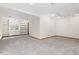 Basement featuring neutral carpet, built-in shelving, and natural light at 11932 W 56Th Cir, Arvada, CO 80002