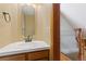 Classic powder room featuring a white vanity and framed mirror at 11932 W 56Th Cir, Arvada, CO 80002
