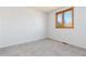 Bedroom featuring neutral carpet and a window offering outside views at 11932 W 56Th Cir, Arvada, CO 80002