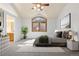 Bright bedroom featuring a vaulted ceiling, a large window, and neutral décor with an ensuite bathroom at 11932 W 56Th Cir, Arvada, CO 80002