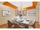 Inviting dining room featuring wood floors, a modern chandelier, and a marble table with seating for six at 11932 W 56Th Cir, Arvada, CO 80002