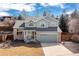 Charming two-story home with a brick facade, well-maintained lawn, attached two-car garage, and inviting front porch at 11932 W 56Th Cir, Arvada, CO 80002