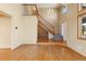 Open foyer showcasing hardwood floors, a staircase, and a view of the living spaces at 11932 W 56Th Cir, Arvada, CO 80002