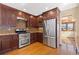 This kitchen features stainless steel appliances, dark wood cabinets and designer tile backsplash at 11932 W 56Th Cir, Arvada, CO 80002