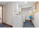 Laundry room with front load washer and dryer, water heater, and patterned wallpaper at 11932 W 56Th Cir, Arvada, CO 80002