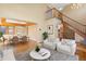 Bright living room showcasing the staircase, wood floors, and an open dining area with stylish décor at 11932 W 56Th Cir, Arvada, CO 80002