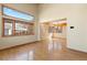 Bright living room featuring hardwood floors, large windows, and high ceilings, offering ample natural light at 11932 W 56Th Cir, Arvada, CO 80002