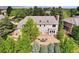 Aerial view of the home featuring a stone patio and lush landscaping at 51 Falcon Hills Dr, Highlands Ranch, CO 80126