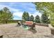 Backyard patio with outdoor furniture, mature trees, and scenic views at 51 Falcon Hills Dr, Highlands Ranch, CO 80126