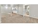 A finished basement features neutral carpet and a door to a bathroom and kitchenette at 51 Falcon Hills Dr, Highlands Ranch, CO 80126
