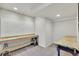 Basement workshop with pegboard, workbench, and overhead lighting at 51 Falcon Hills Dr, Highlands Ranch, CO 80126