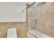 A neutral bathroom features a tile shower-tub, ceramic tile flooring, and a white toilet at 51 Falcon Hills Dr, Highlands Ranch, CO 80126