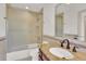 Bright bathroom features a granite vanity top, decorative backsplash, and shower-tub combo at 51 Falcon Hills Dr, Highlands Ranch, CO 80126