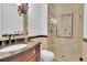 Bathroom featuring an elegant vanity, framed mirror, and walk-in shower at 51 Falcon Hills Dr, Highlands Ranch, CO 80126
