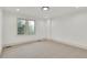 A bedroom features neutral carpet, white walls, and a window to let in natural light at 51 Falcon Hills Dr, Highlands Ranch, CO 80126