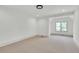 A bright bedroom shows neutral carpet, white trim, and a large window to let in natural light at 51 Falcon Hills Dr, Highlands Ranch, CO 80126