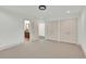 A bedroom shows neutral carpet, three closets, and a door to a bathroom at 51 Falcon Hills Dr, Highlands Ranch, CO 80126