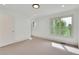 Bright and spacious bedroom features neutral carpet and large windows with tree views at 51 Falcon Hills Dr, Highlands Ranch, CO 80126