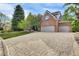 Brick home with a three-car garage and a paved driveway at 51 Falcon Hills Dr, Highlands Ranch, CO 80126