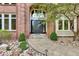 Stately home front door with stone walkway and manicured garden bed, leading to a welcoming entryway at 51 Falcon Hills Dr, Highlands Ranch, CO 80126