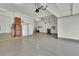 Clean, organized garage with epoxy floors, shelving, and a double refrigerator at 51 Falcon Hills Dr, Highlands Ranch, CO 80126