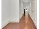 Bright hallway with hardwood floors, white walls and baseboards at 51 Falcon Hills Dr, Highlands Ranch, CO 80126
