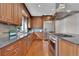 Spacious kitchen featuring custom cabinets, modern appliances, granite countertops, and hardwood floors at 51 Falcon Hills Dr, Highlands Ranch, CO 80126