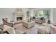 Bright living room with fireplace, hardwood floors, and a large window view at 51 Falcon Hills Dr, Highlands Ranch, CO 80126