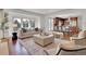 Beautiful living room with backyard view, fireplace and open to the kitchen at 51 Falcon Hills Dr, Highlands Ranch, CO 80126