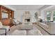 Spacious living room with fireplace, built-in shelves and two accent chairs at 51 Falcon Hills Dr, Highlands Ranch, CO 80126
