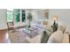Bright living room featuring large windows, neutral furniture, and a stylish glass coffee table at 51 Falcon Hills Dr, Highlands Ranch, CO 80126