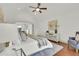 Main bedroom with a ceiling fan, accent chair and view to hallway at 51 Falcon Hills Dr, Highlands Ranch, CO 80126
