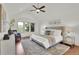 Spacious main bedroom with a ceiling fan, accent chair and large windows at 51 Falcon Hills Dr, Highlands Ranch, CO 80126
